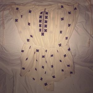 Cream romper with blue and gold embroidery